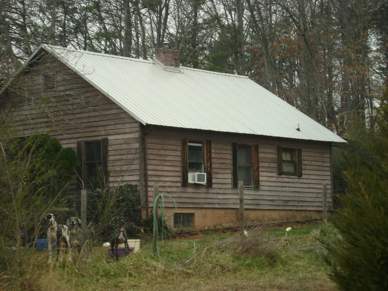White metal roof on an old wood sided farmhouse, from a Metal Roof Installation job in Crown Point